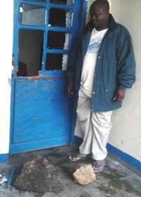 Vice Chancellor Sabiti examines the damage on the campus in Congo