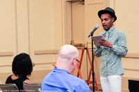 Kevin Smallwood reads a reflection about being racially profiled by hotel security.