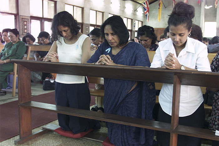 Mark -Baker -Reuters _Virmati -Chaudhry -centre -wife -Fiji -deposed -PM-Mahendra -Chaudhry -daughter -Ranidaily -left -prayer -vigil -Holy -Trinity -Cathedral -Suva -000702_700x 467
